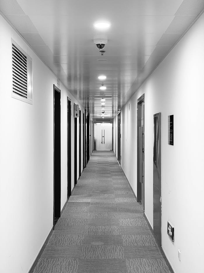 about-us Black and white view of a symmetrical corporate office hallway in Beijing, China.