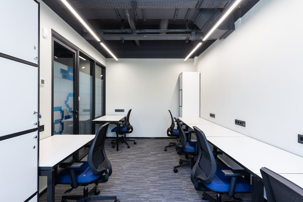Clean and contemporary office workspace with modern furniture and minimalist decor.